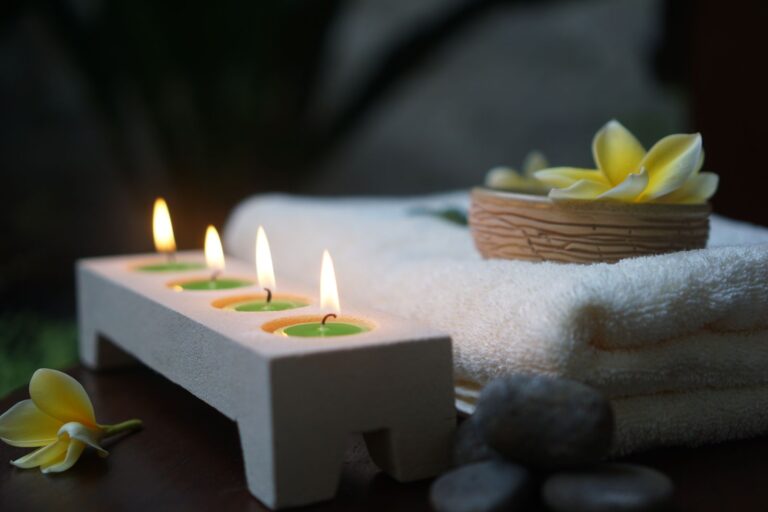 Lit candles and folded towels ready for a treatment