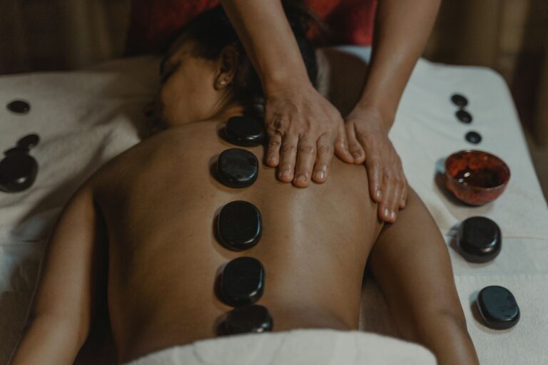 Warm basalt stones placed along a client's back during hot stone therapy