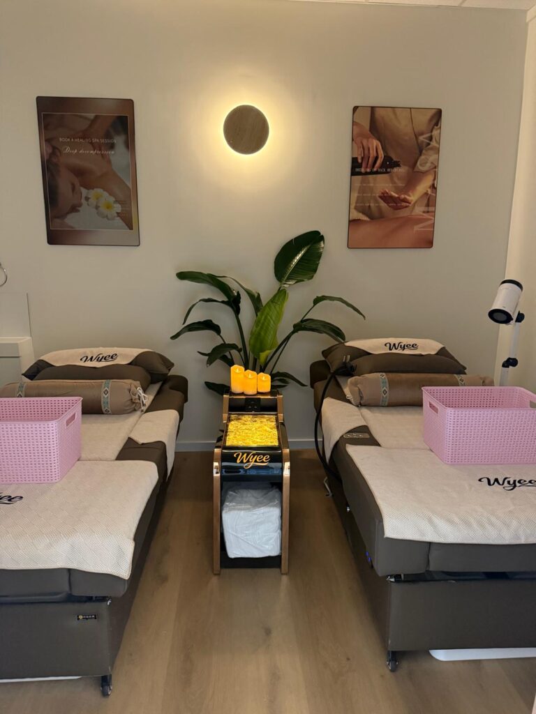 Twin treatment room with two massage beds and soft lighting at The Royal Orchid